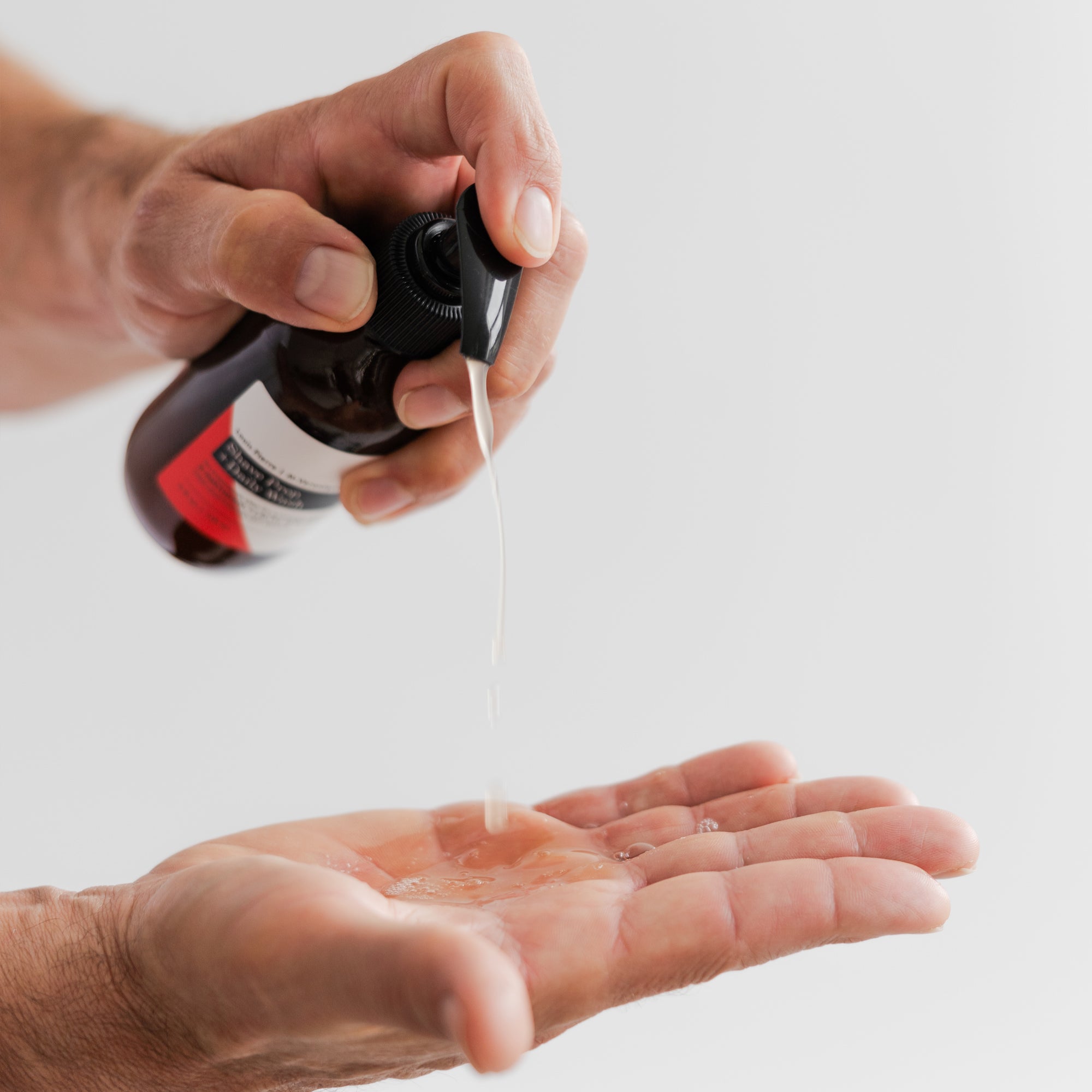 Hand using pump to show texture of Marie Veronique Men's collection shave prep and daily wash.This lightly foaming daily cleanser removes dirt and excess oil and preps the skin for a close, comfortable shave. Willow bark penetrates deeply to soften hair follicles, while lactic acid exfoliates to counteract congestion and dull texture. The result is deep cleansing and smooth shaving without stripping or drying the skin.