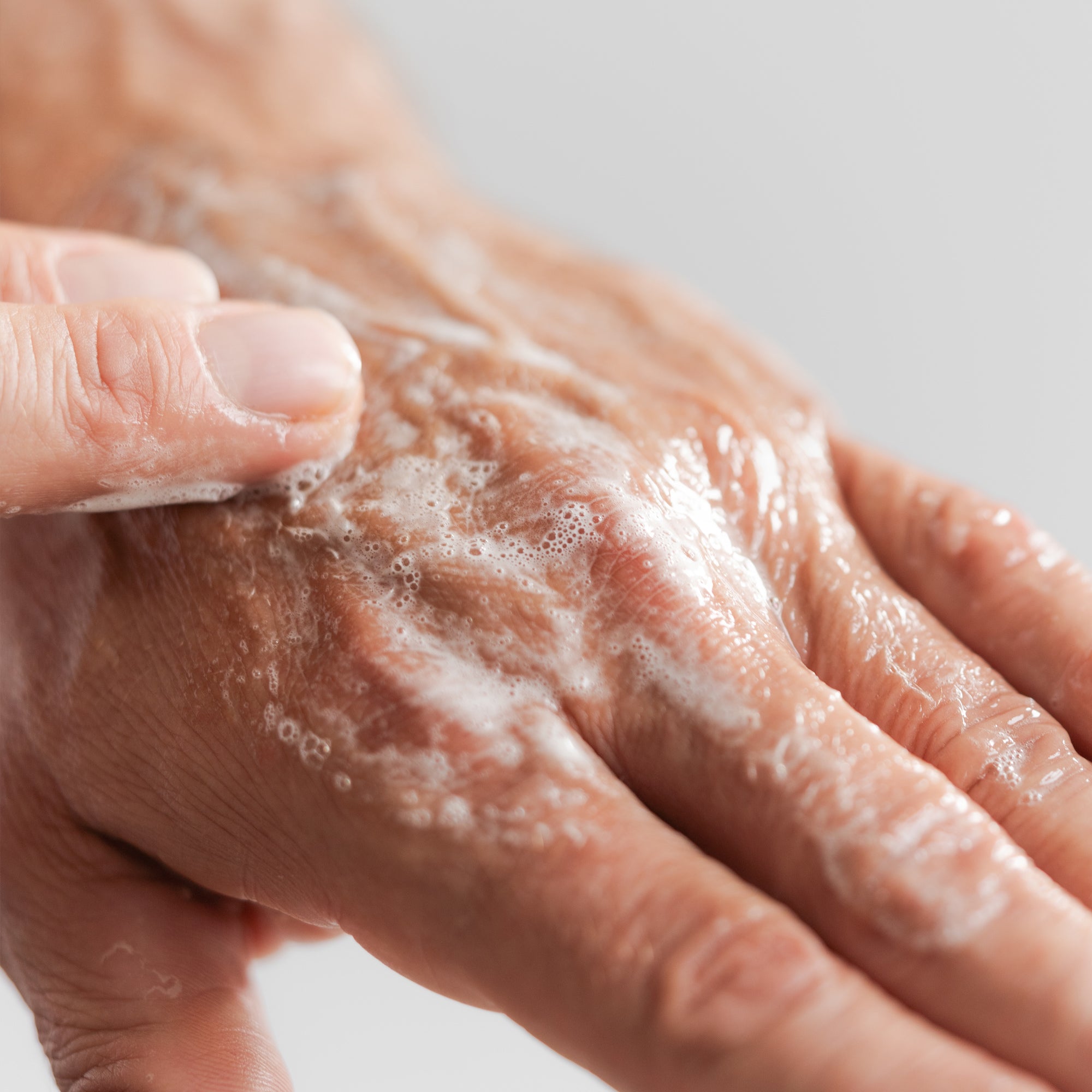 Hand showing lathering of Marie Veronique Men's collection shave prep and daily wash.This lightly foaming daily cleanser removes dirt and excess oil and preps the skin for a close, comfortable shave. Willow bark penetrates deeply to soften hair follicles, while lactic acid exfoliates to counteract congestion and dull texture. The result is deep cleansing and smooth shaving without stripping or drying the skin.